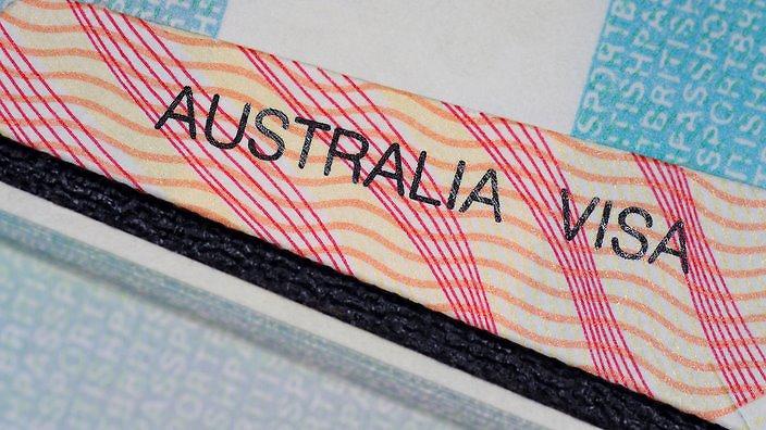 australian visa in between two british passport pages